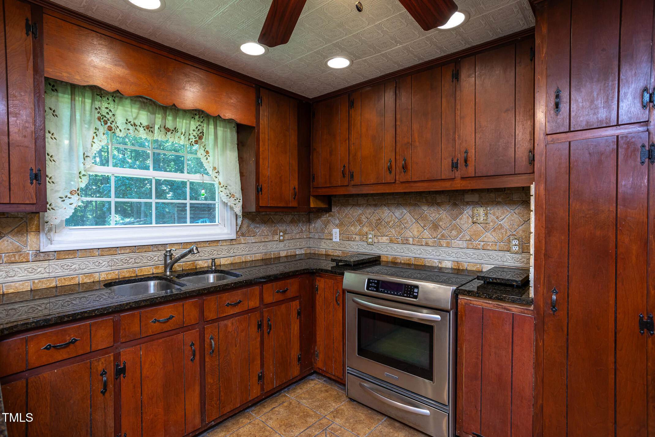 3622 Chestnut Ridge Church Road Efland, NC 27243 - Photo 4 of 22 a kitchen with stainless steel appliances granite countertop wooden cabinets a sink and a large window
