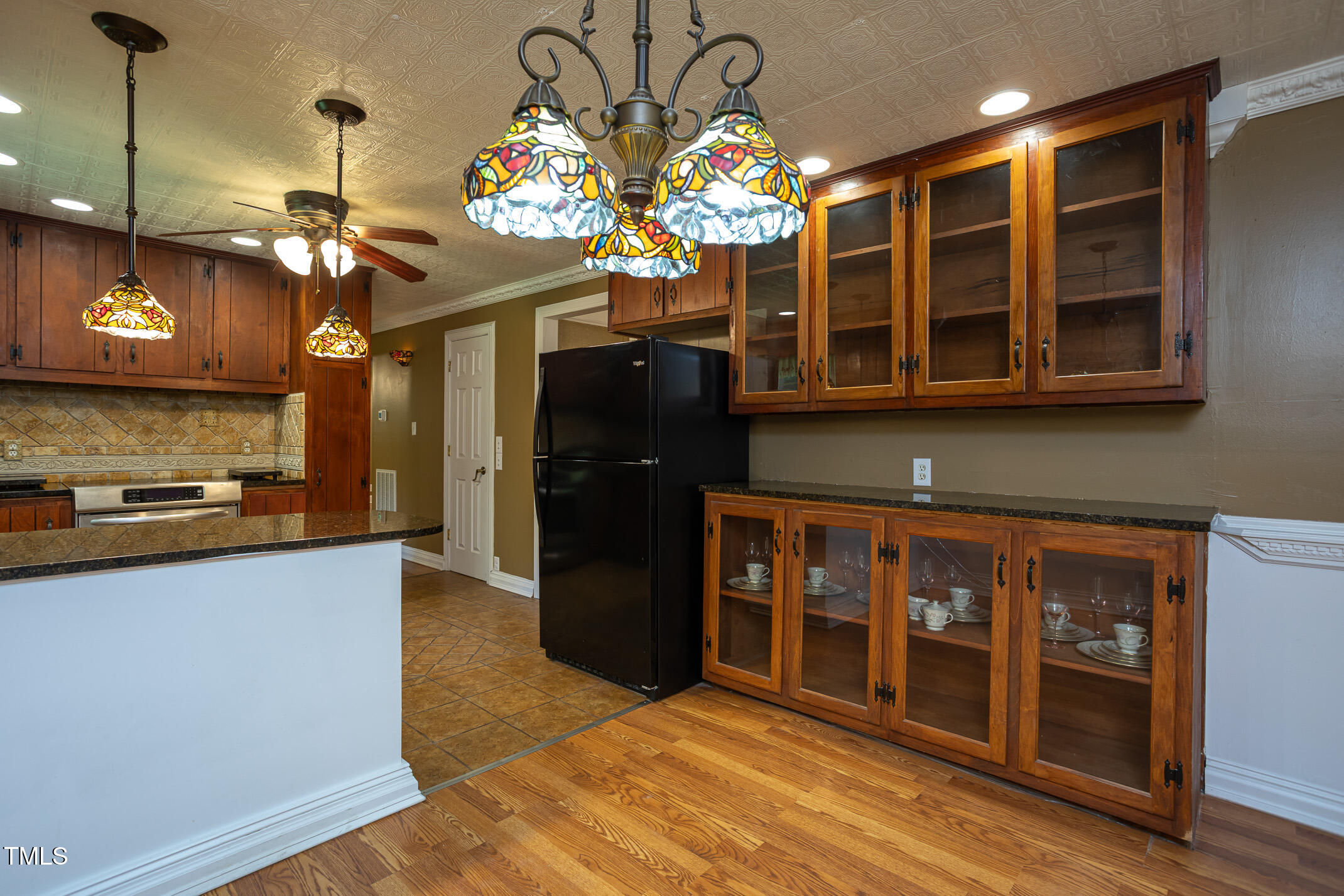 3622 Chestnut Ridge Church Road Efland, NC 27243 - Photo 6 of 22 a kitchen with a refrigerator and chandelier