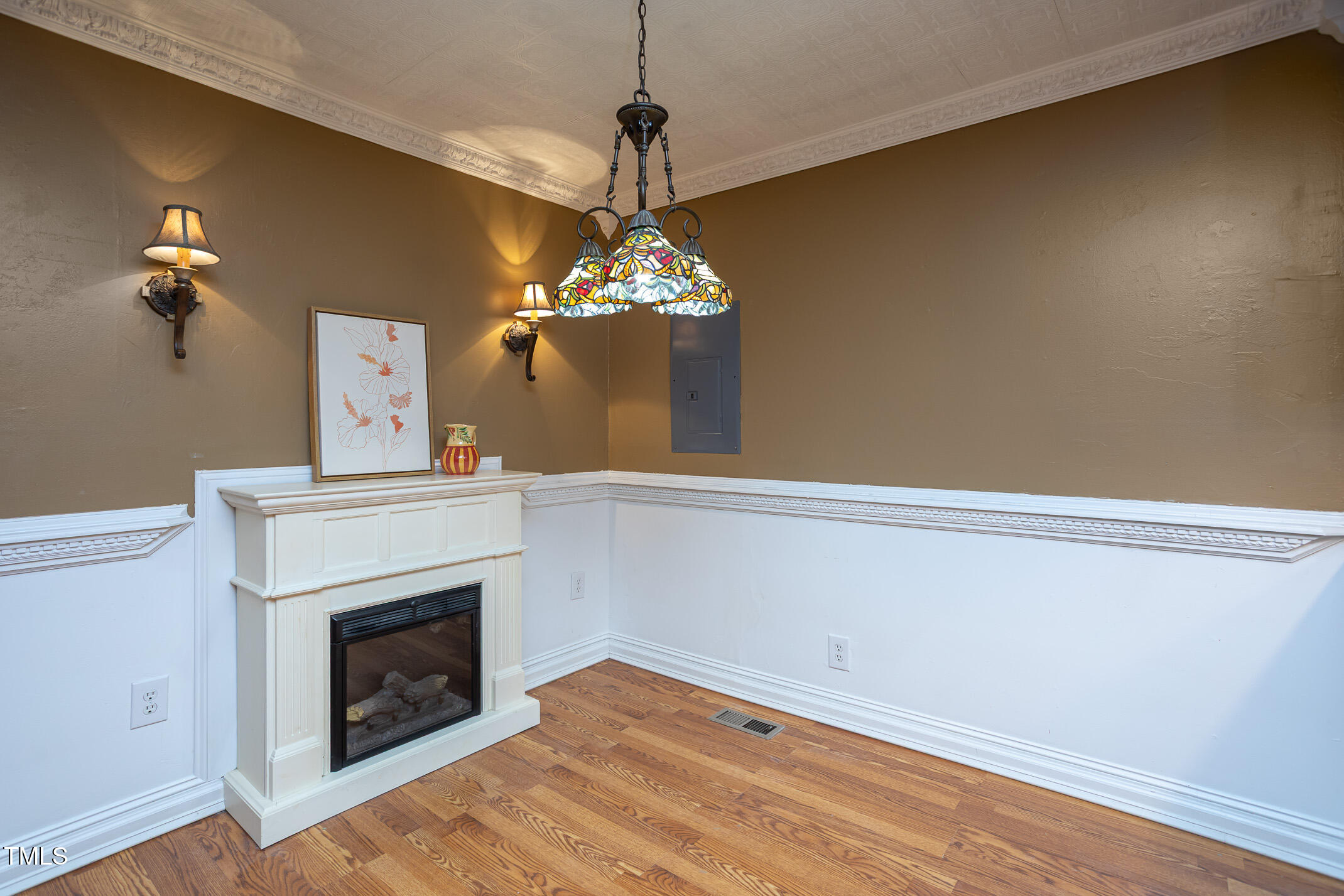 3622 Chestnut Ridge Church Road Efland, NC 27243 - Photo 7 of 22 a room with a fireplace and chandelier