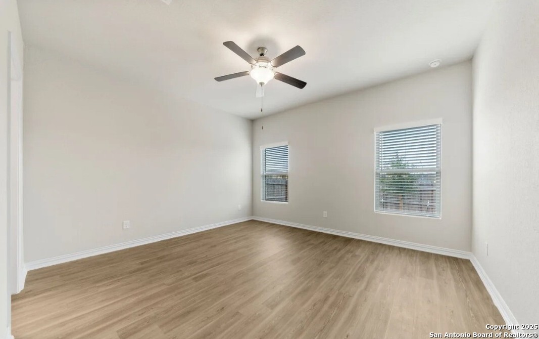 5423 Devils Gate Converse, TX 78109 - Photo 12 of 17 a view of an empty room with wooden floor and a window