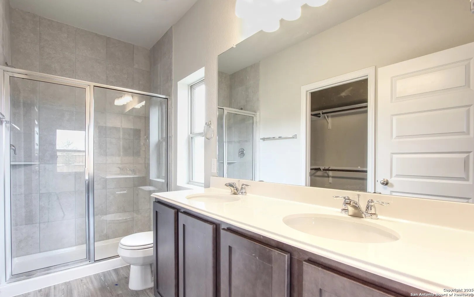 5423 Devils Gate Converse, TX 78109 - Photo 13 of 17 a bathroom with a granite countertop sink toilet and shower