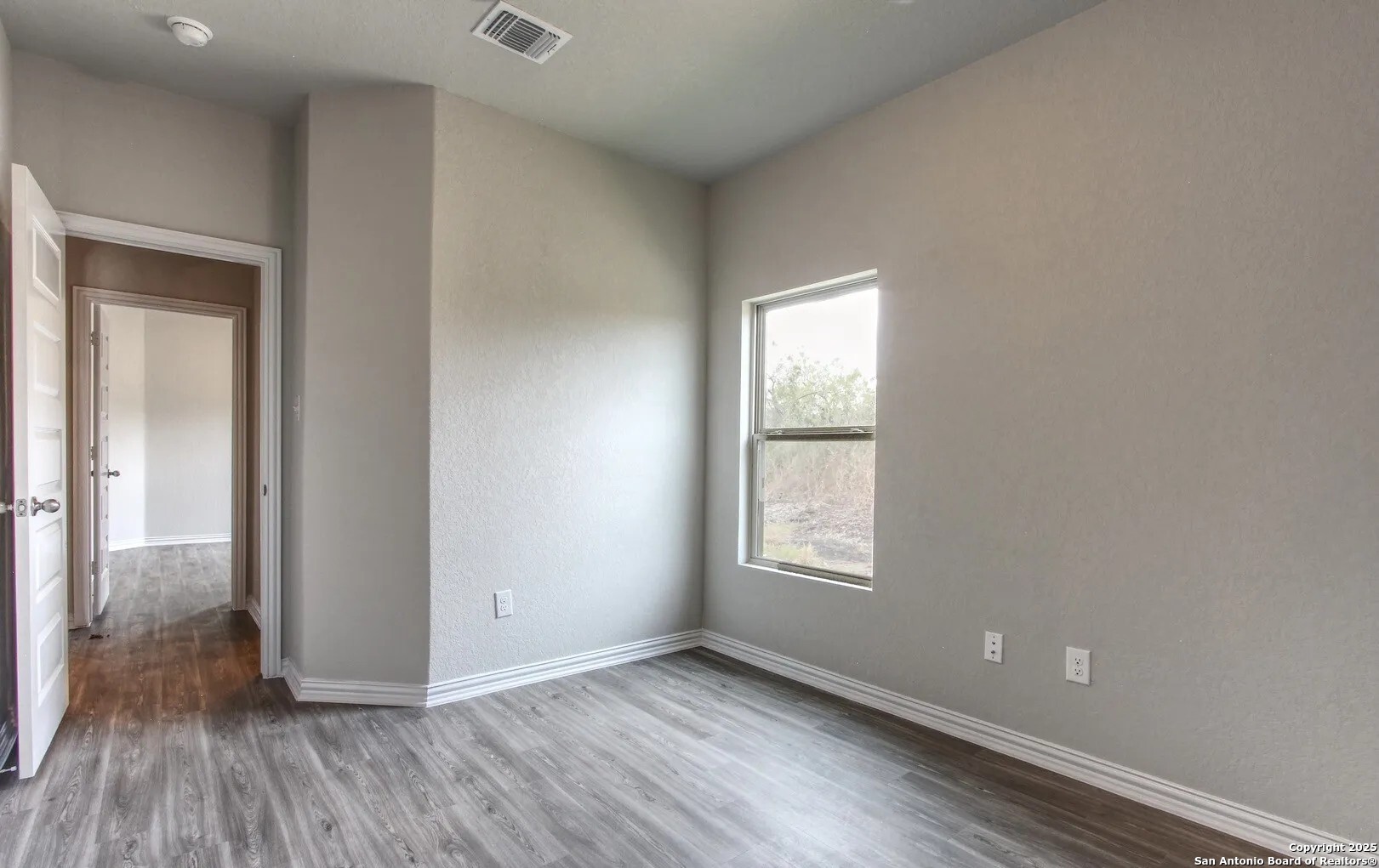 5423 Devils Gate Converse, TX 78109 - Photo 16 of 17 an empty room with wooden floor and windows