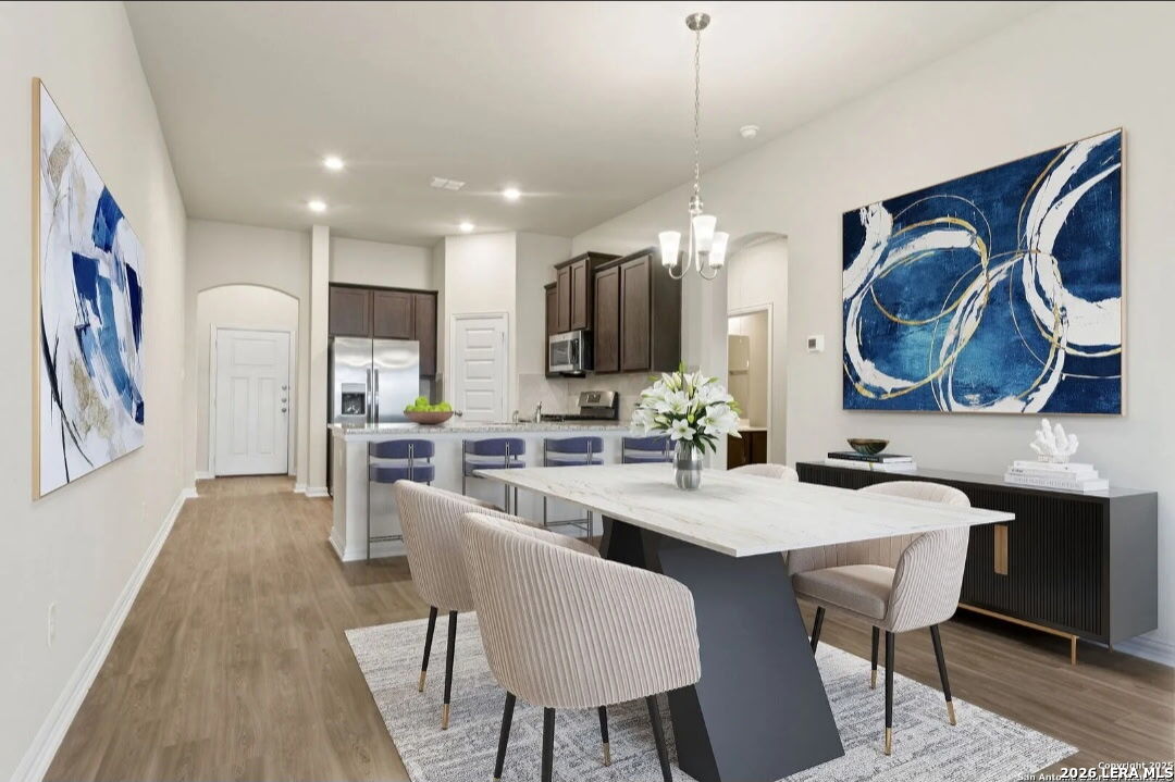 5423 Devils Gate Converse, TX 78109 - Photo 3 of 17 a kitchen with a dining table chairs sink and cabinets