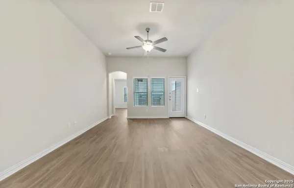 a view of a kitchen with kitchen island a sink wooden floor and glass door