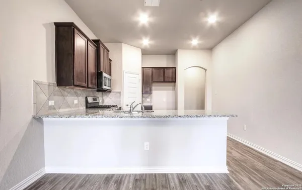 a kitchen with a refrigerator sink and microwave