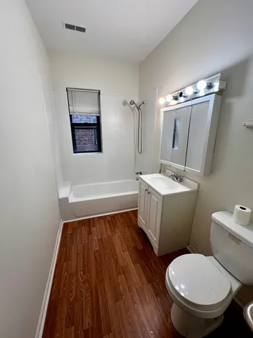 a white toilet sitting next to a bathroom sink