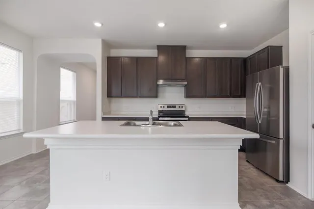 a kitchen with stainless steel appliances a refrigerator and a sink