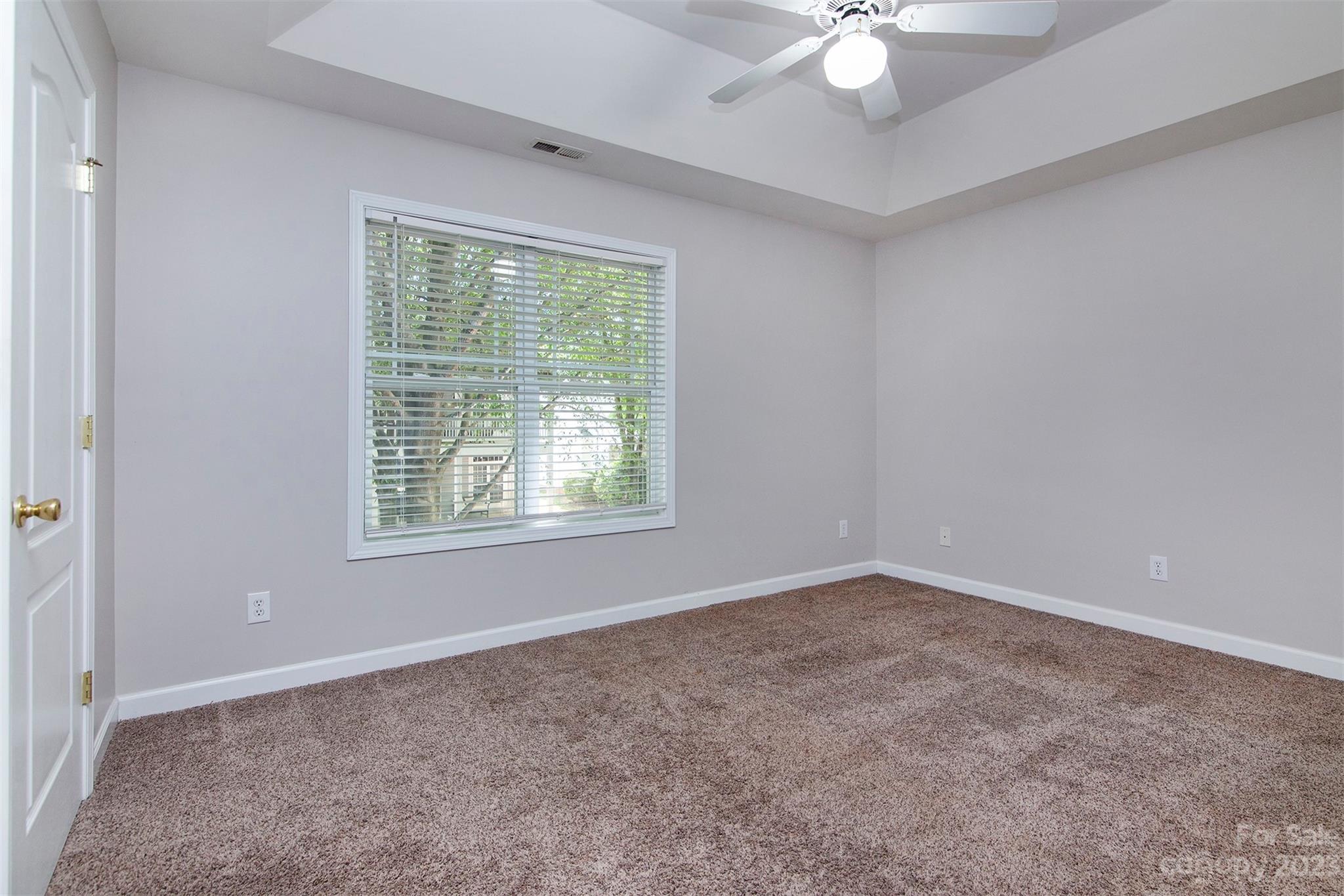 13111 Meadowmere Road Huntersville, NC 28078 - Photo 12 of 21 an empty room with a chandelier fan and windows