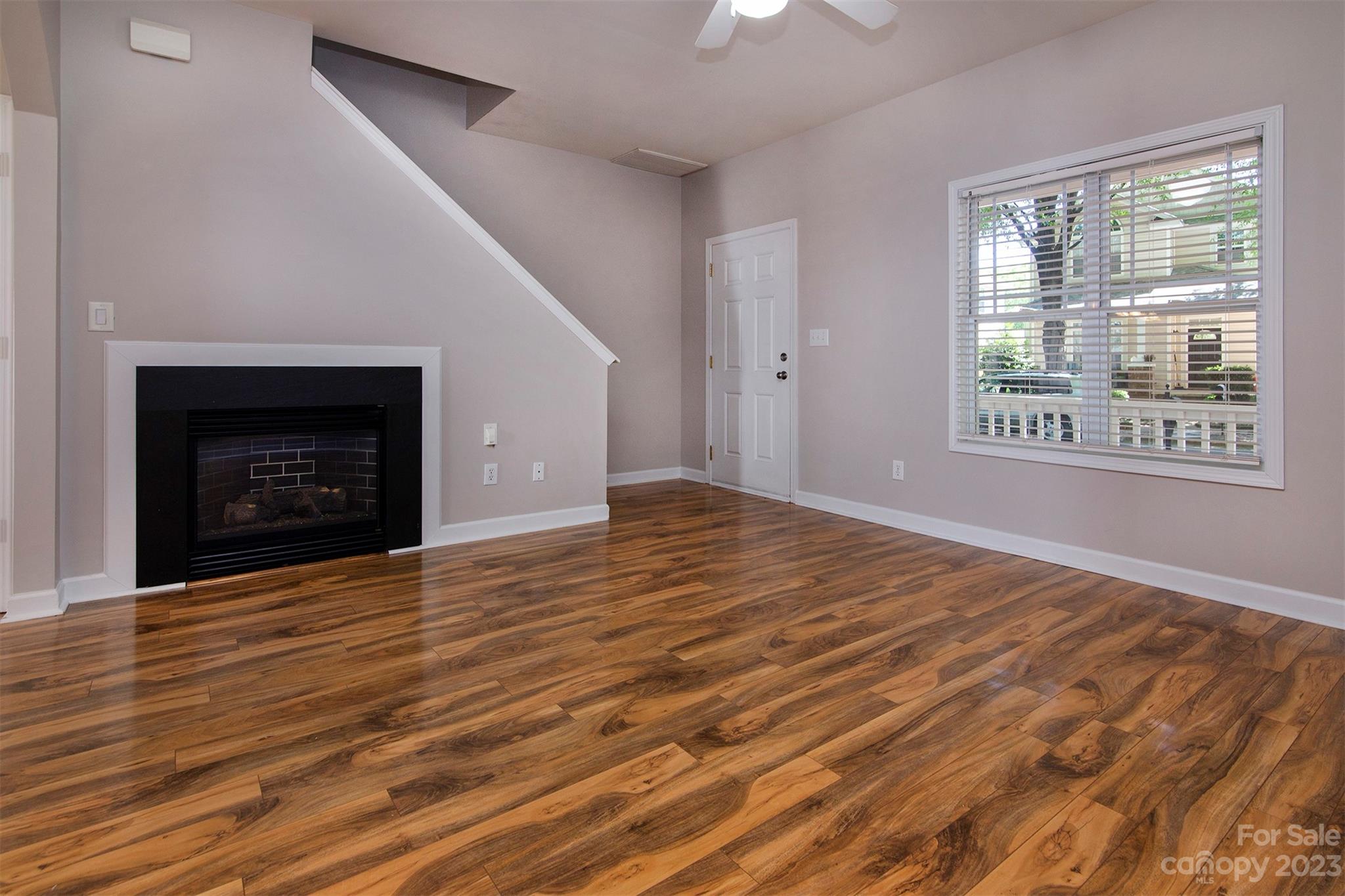 13111 Meadowmere Road Huntersville, NC 28078 - Photo 3 of 21 a view of an empty room with wooden floor fireplace and a window