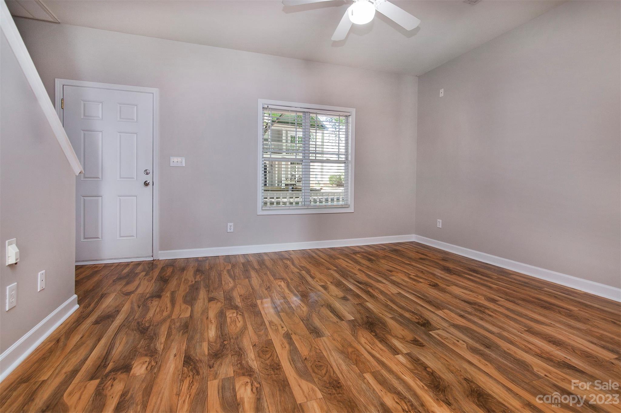 13111 Meadowmere Road Huntersville, NC 28078 - Photo 4 of 21 a view of an empty room with wooden floor and a window