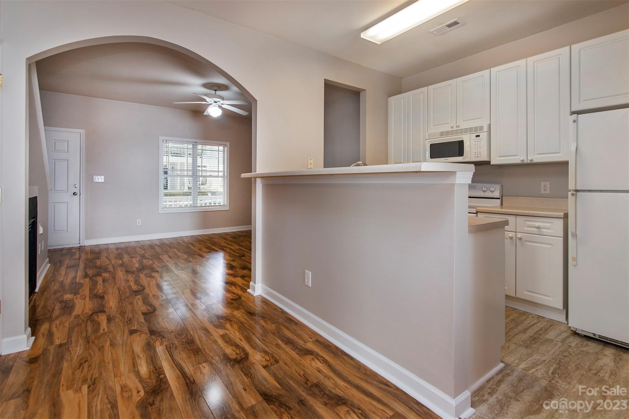 13111 Meadowmere Road Huntersville, NC 28078 - Photo 6 of 21 a kitchen with white cabinets and wooden floor