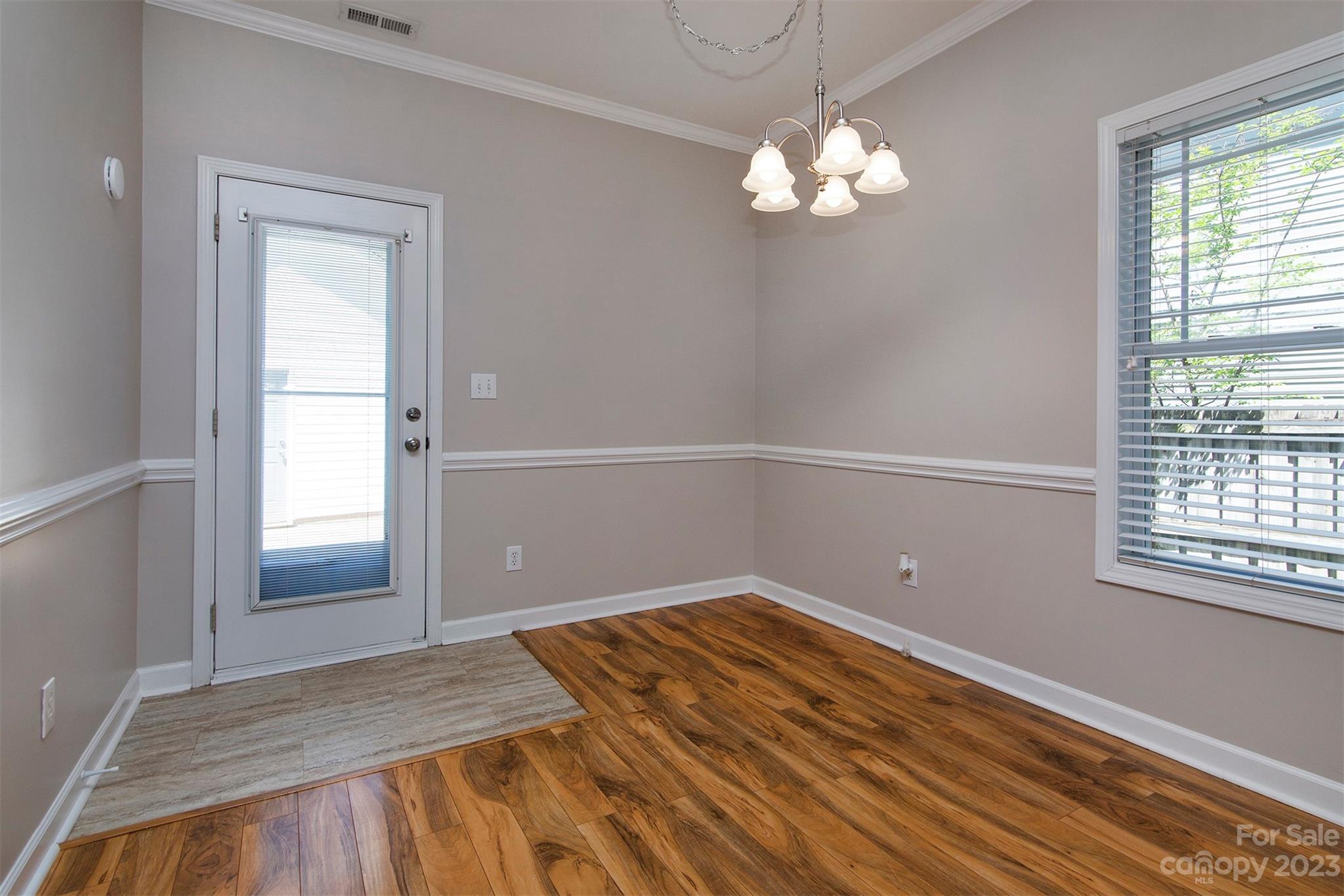 13111 Meadowmere Road Huntersville, NC 28078 - Photo 7 of 21 a view of a room with wooden floor and chandelier