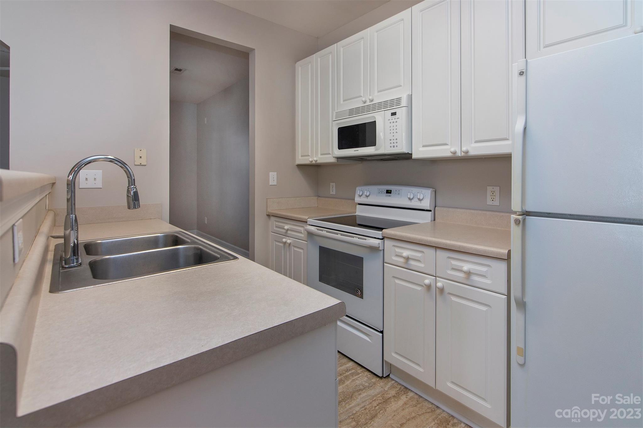 13111 Meadowmere Road Huntersville, NC 28078 - Photo 10 of 21 a kitchen with white cabinets sink and white appliances