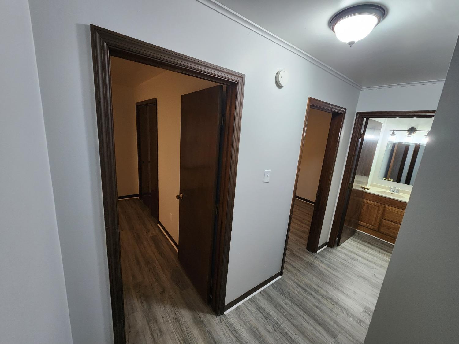 812 West Daumer Road, Unit C1 Kouts, IN 46347 - Photo 19 of 19 a view of a hallway with wooden floor and a refrigerator