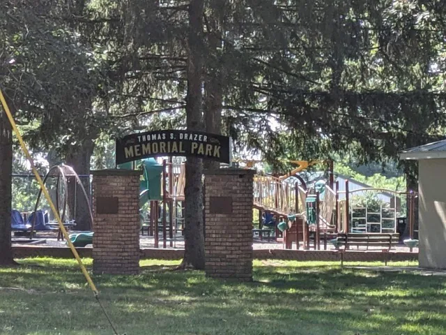 a view of a park with iron fence