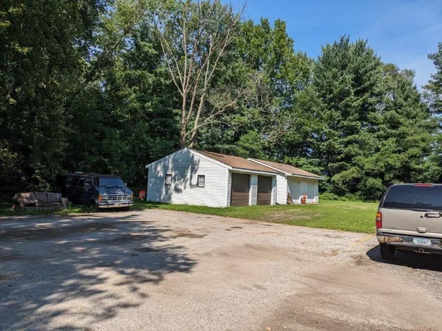 a car parked in front of a house with a yard