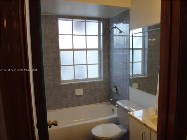 a bathroom with a tub toilet and sink