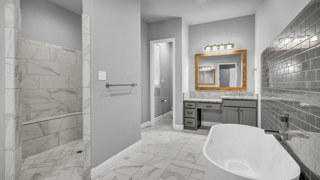 115 Post Oak Way Weatherford, TX 76087 - Photo 16 of 39 Full bath with vanity, light marble finish floors, a soaking tub, and a walk in shower