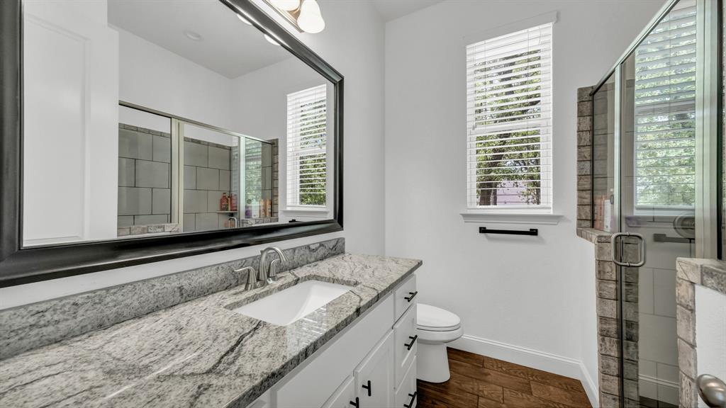 115 Post Oak Way Weatherford, TX 76087 - Photo 19 of 39 Full bathroom featuring a shower stall, vanity, and dark wood finished floors