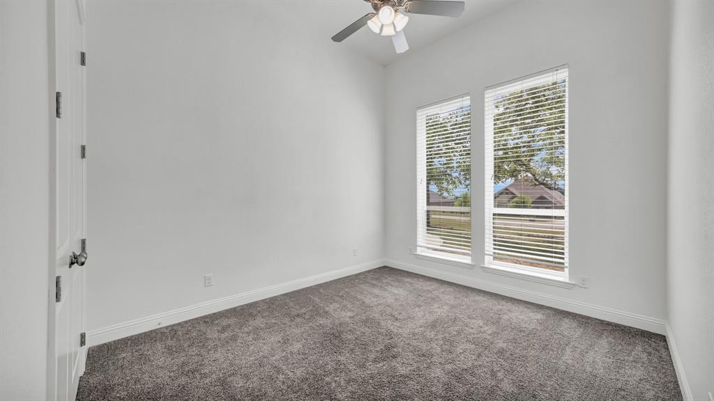 115 Post Oak Way Weatherford, TX 76087 - Photo 22 of 39 Carpeted empty room with a ceiling fan and baseboards
