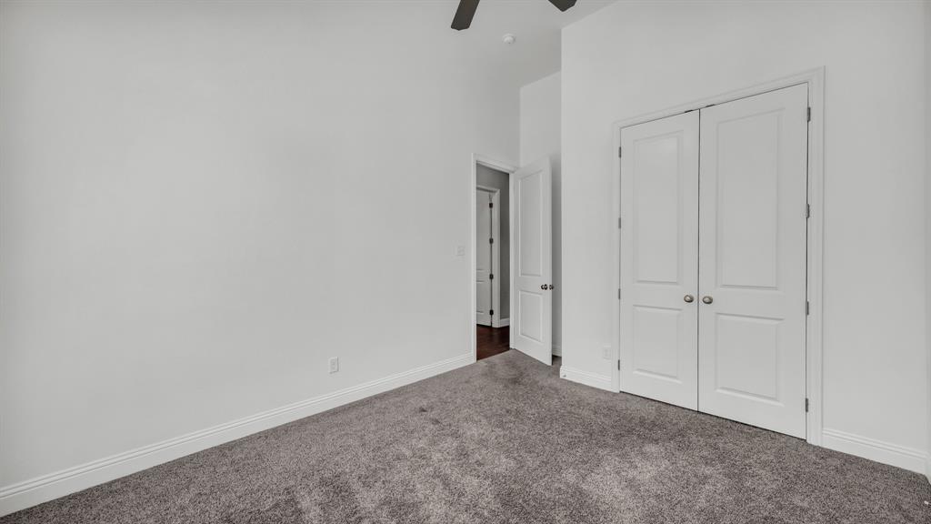 115 Post Oak Way Weatherford, TX 76087 - Photo 23 of 39 Unfurnished bedroom with carpet flooring, a closet, ceiling fan, and a high ceiling