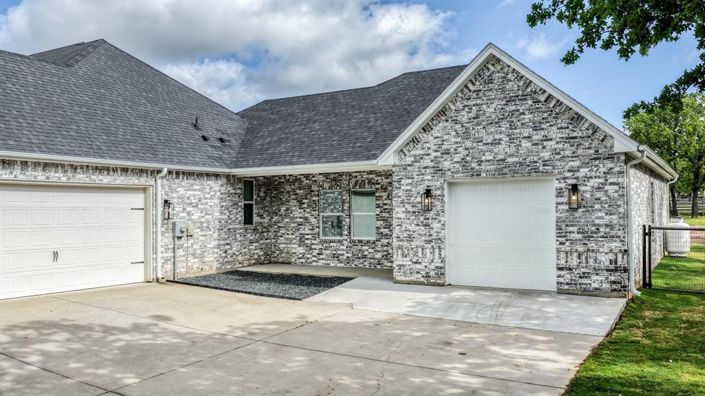 115 Post Oak Way Weatherford, TX 76087 - Photo 25 of 39 Ranch-style house featuring an attached garage, brick siding, and driveway