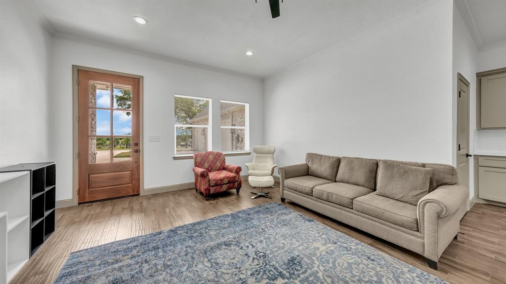 115 Post Oak Way Weatherford, TX 76087 - Photo 26 of 39 Living room featuring light wood-type flooring, crown molding, recessed lighting, and ceiling fan