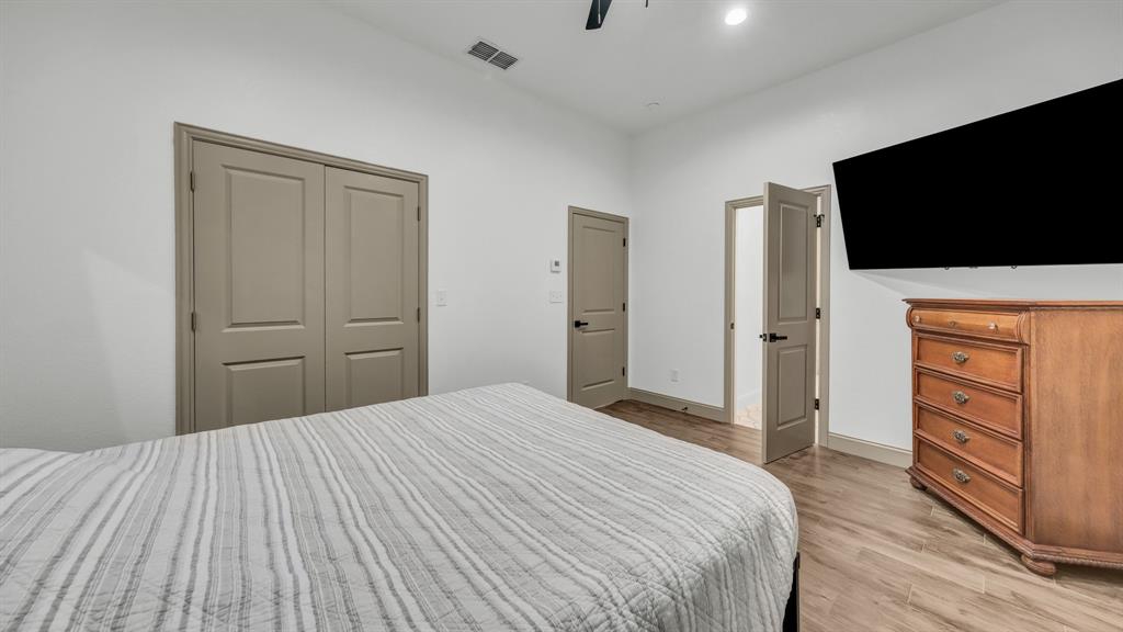 115 Post Oak Way Weatherford, TX 76087 - Photo 31 of 39 Bedroom featuring a ceiling fan, light wood-style floors, and a closet