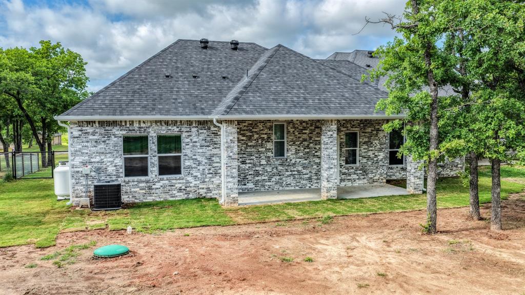 115 Post Oak Way Weatherford, TX 76087 - Photo 32 of 39 Rear view of property with a patio, roof with shingles, and brick siding
