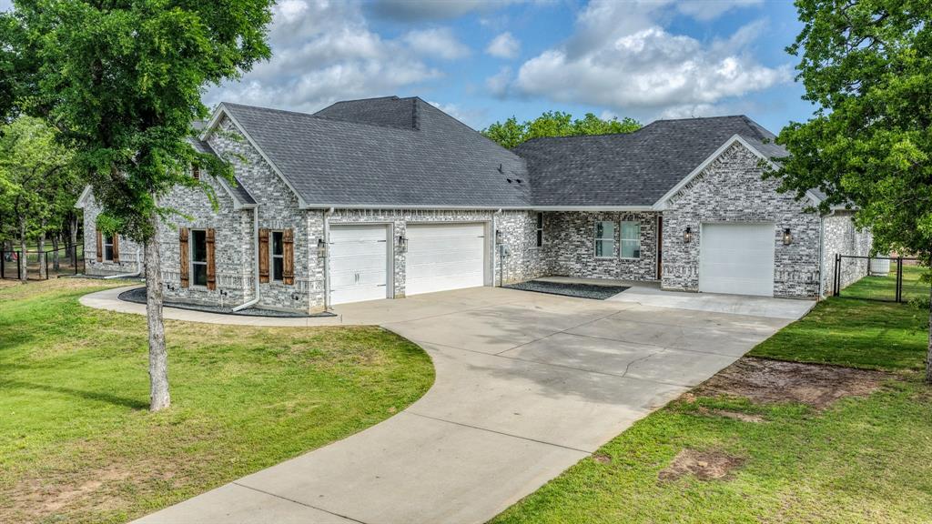 115 Post Oak Way Weatherford, TX 76087 - Photo 4 of 39 View of front of home with an attached garage, a front yard, and concrete driveway