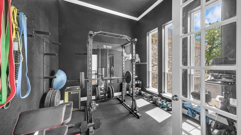 115 Post Oak Way Weatherford, TX 76087 - Photo 6 of 39 Exercise area with crown molding and dark rubber floors