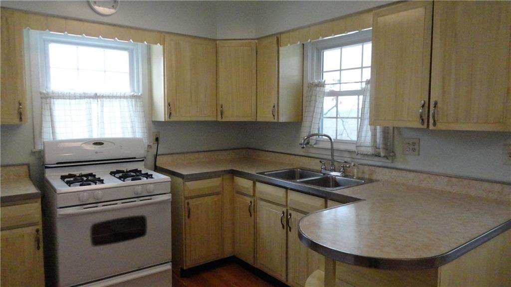 212 North Duffy Road Butler, PA 16001 - Photo 11 of 25 Bright and suunny Kitchen, with gas stove, Fridge and good sized Pantry to the left. Double Stainless Sink. Good cabinet space...overlooks wonderful yard.