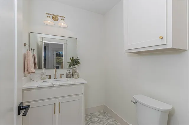 a bathroom with a sink a toilet and mirror