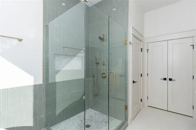 a bathroom with a shower and a glass door