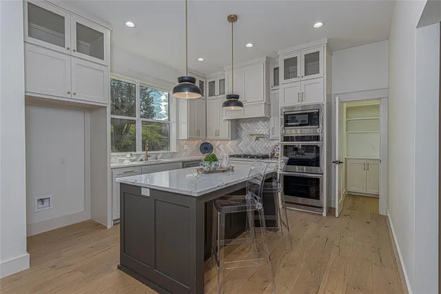 a kitchen with stainless steel appliances granite countertop a stove and a refrigerator