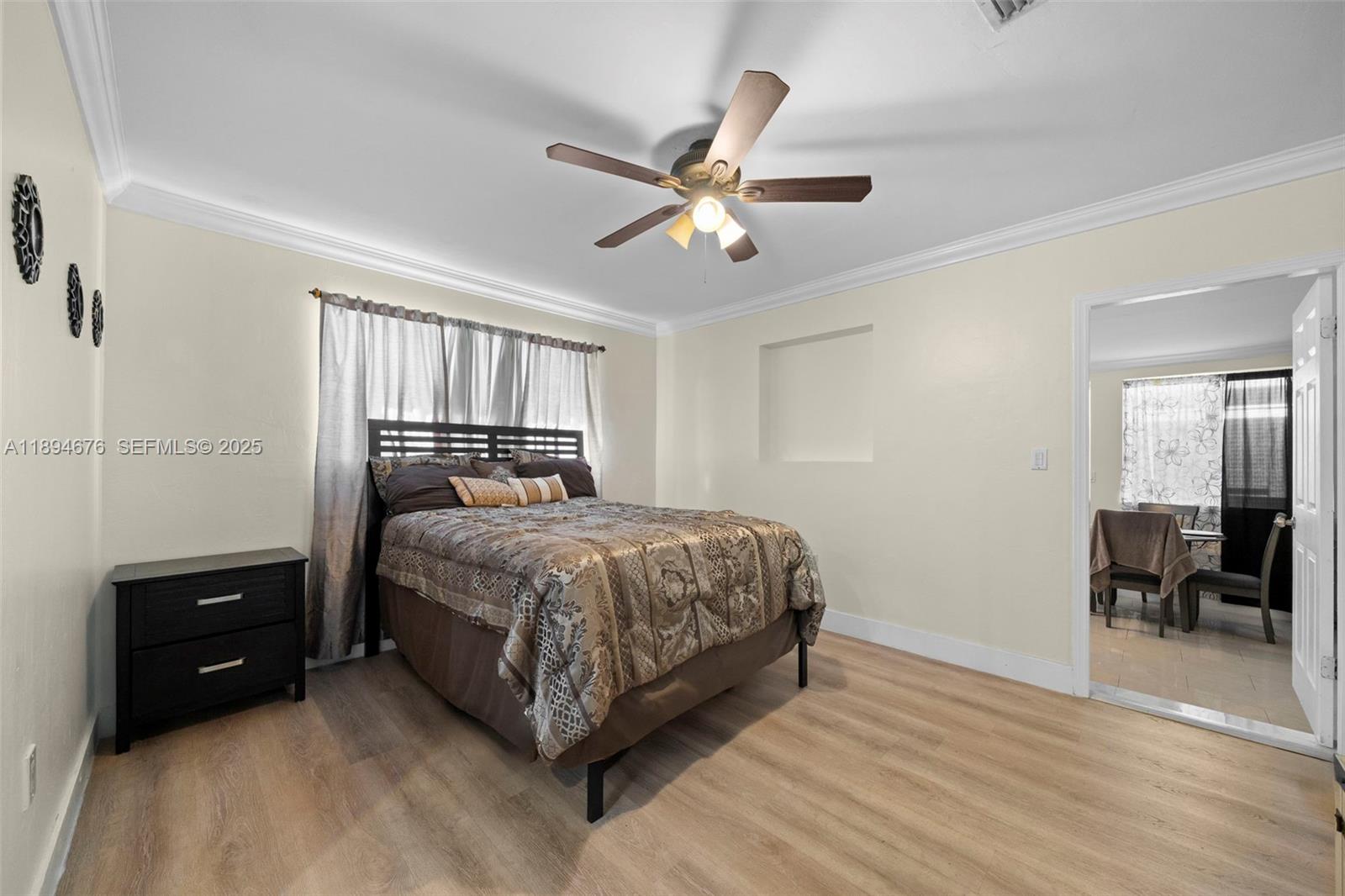 1271 Northwest 87th Street Miami, FL 33147 - Photo 14 of 29 a bedroom with a bed and a chandelier