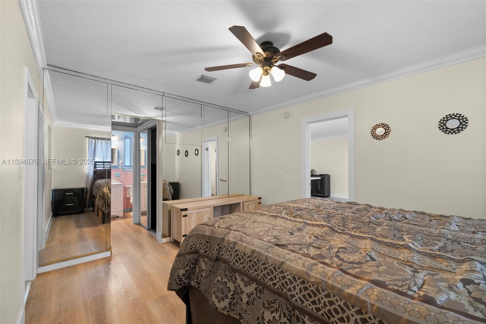 1271 Northwest 87th Street Miami, FL 33147 - Photo 15 of 29 a spacious bedroom with a large bed and a chandelier