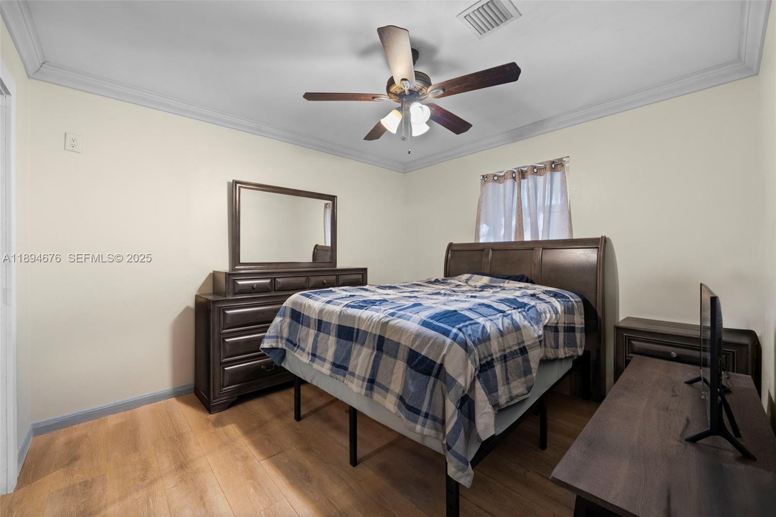 1271 Northwest 87th Street Miami, FL 33147 - Photo 16 of 29 a bedroom with a bed and a chandelier