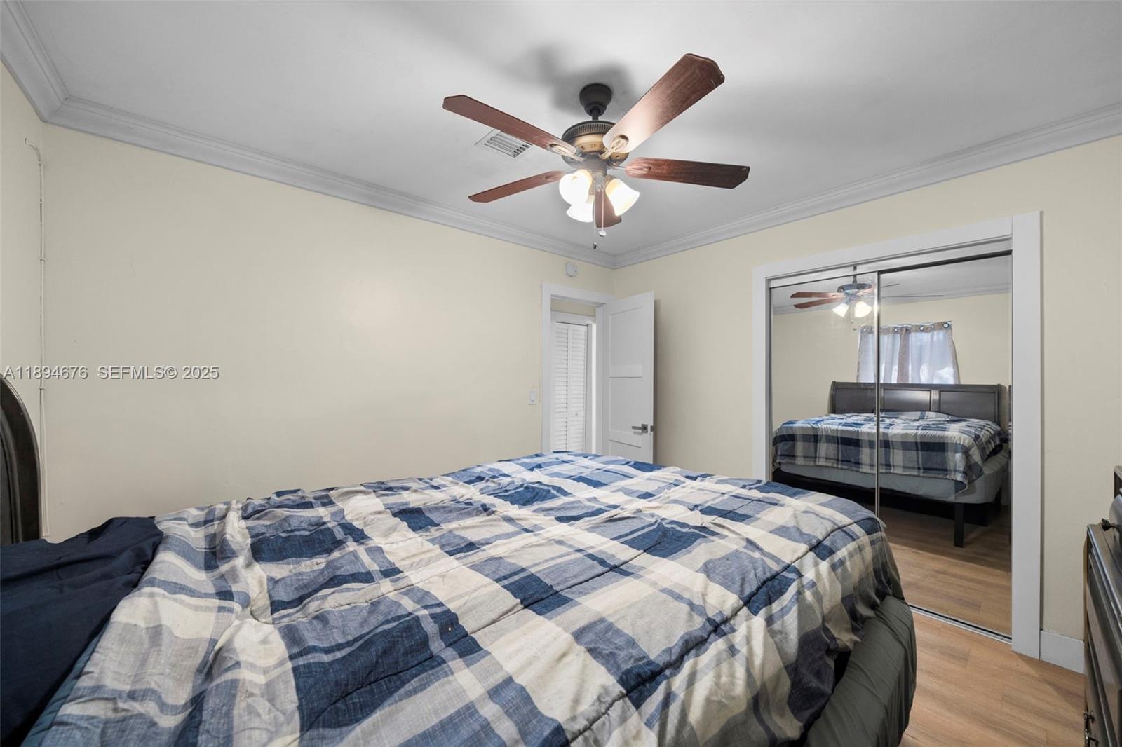 1271 Northwest 87th Street Miami, FL 33147 - Photo 17 of 29 a bedroom with a bed and a chandelier