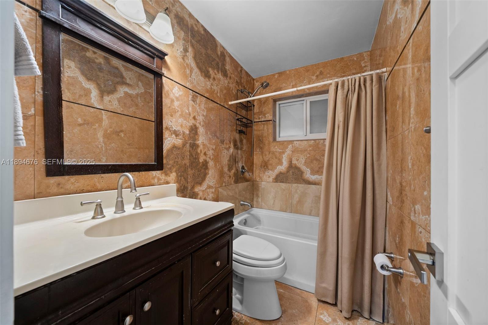 1271 Northwest 87th Street Miami, FL 33147 - Photo 18 of 29 a bathroom with a sink a toilet and shower