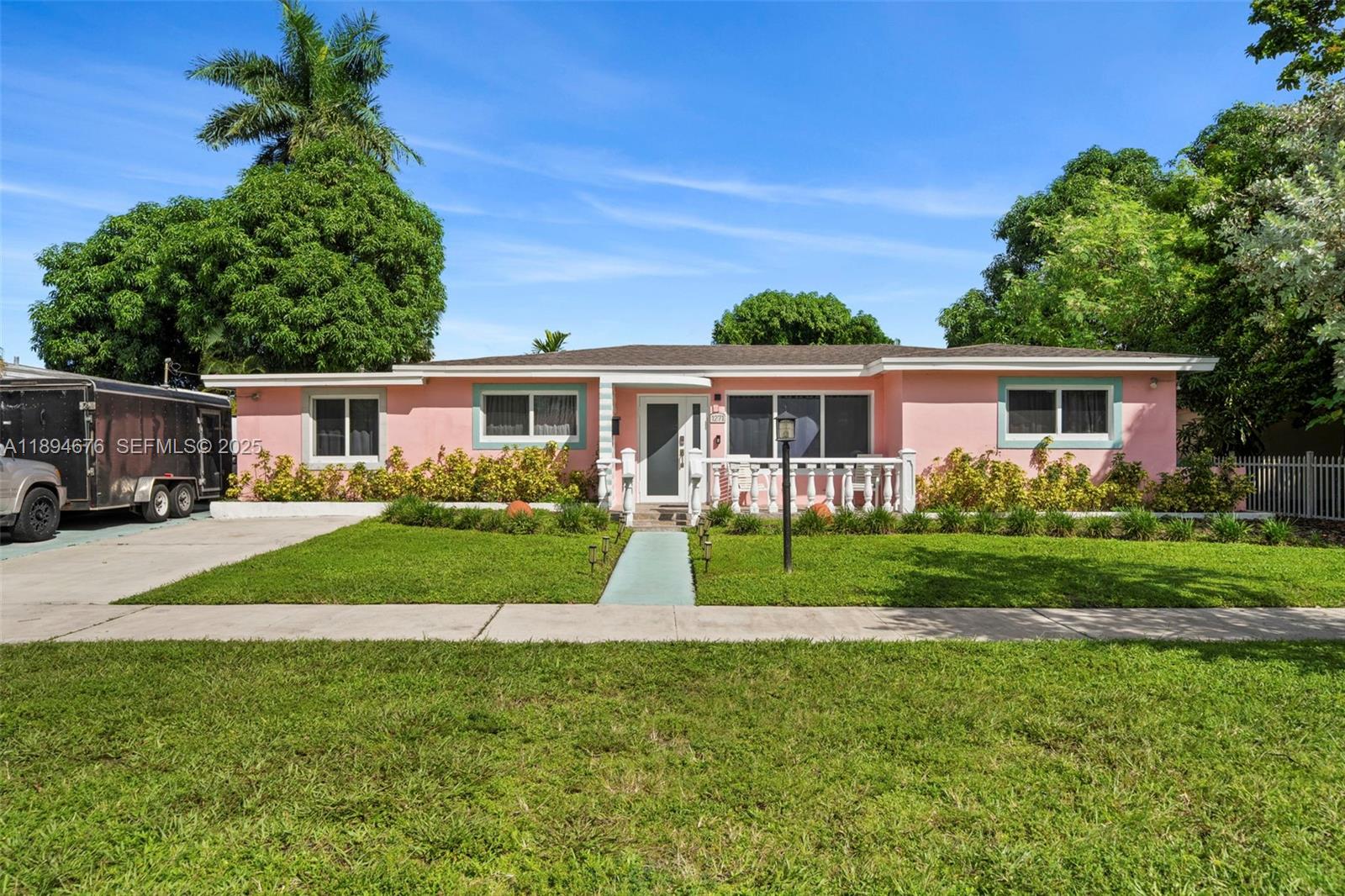1271 Northwest 87th Street Miami, FL 33147 - Photo 2 of 29 a front view of a house with a yard and potted plants