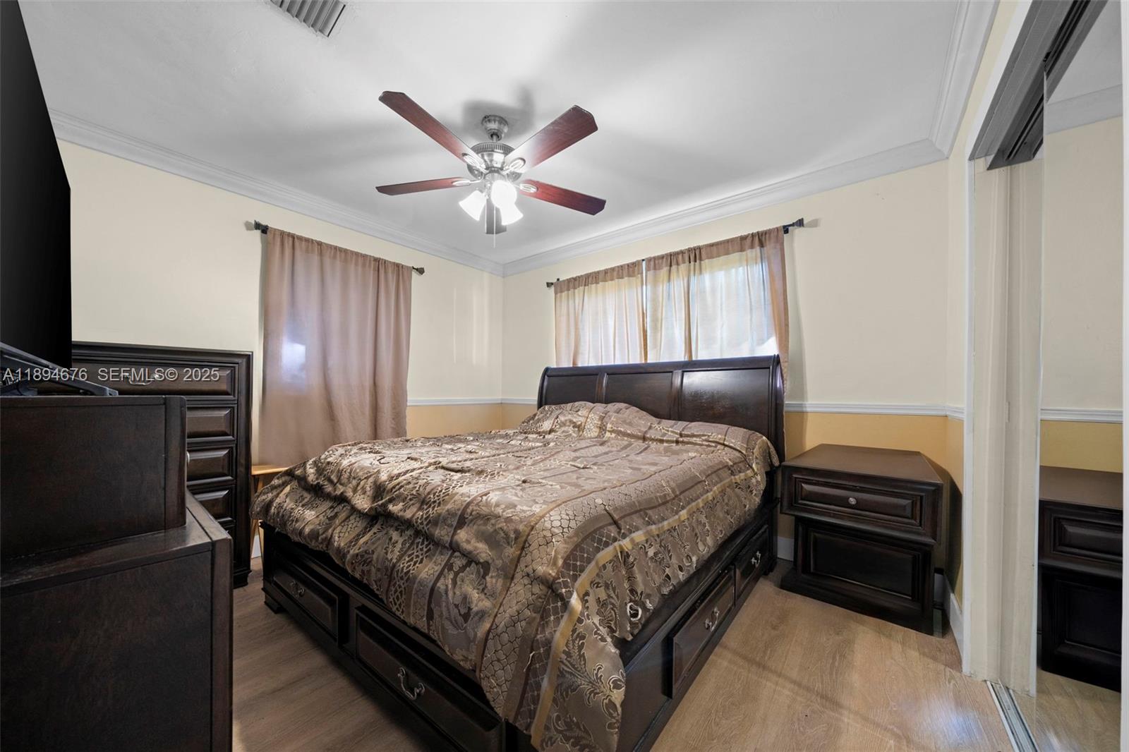 1271 Northwest 87th Street Miami, FL 33147 - Photo 21 of 29 a bedroom with a bed and a flat screen tv