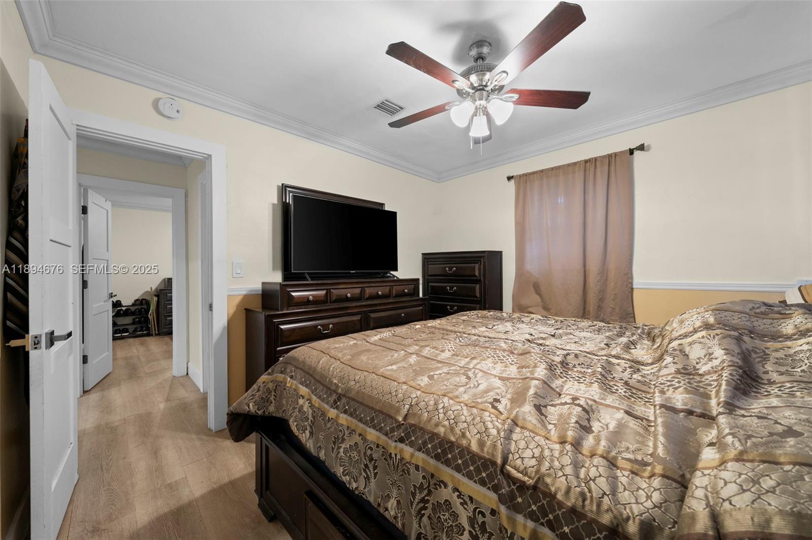1271 Northwest 87th Street Miami, FL 33147 - Photo 22 of 29 a bedroom with a bed and a flat screen tv
