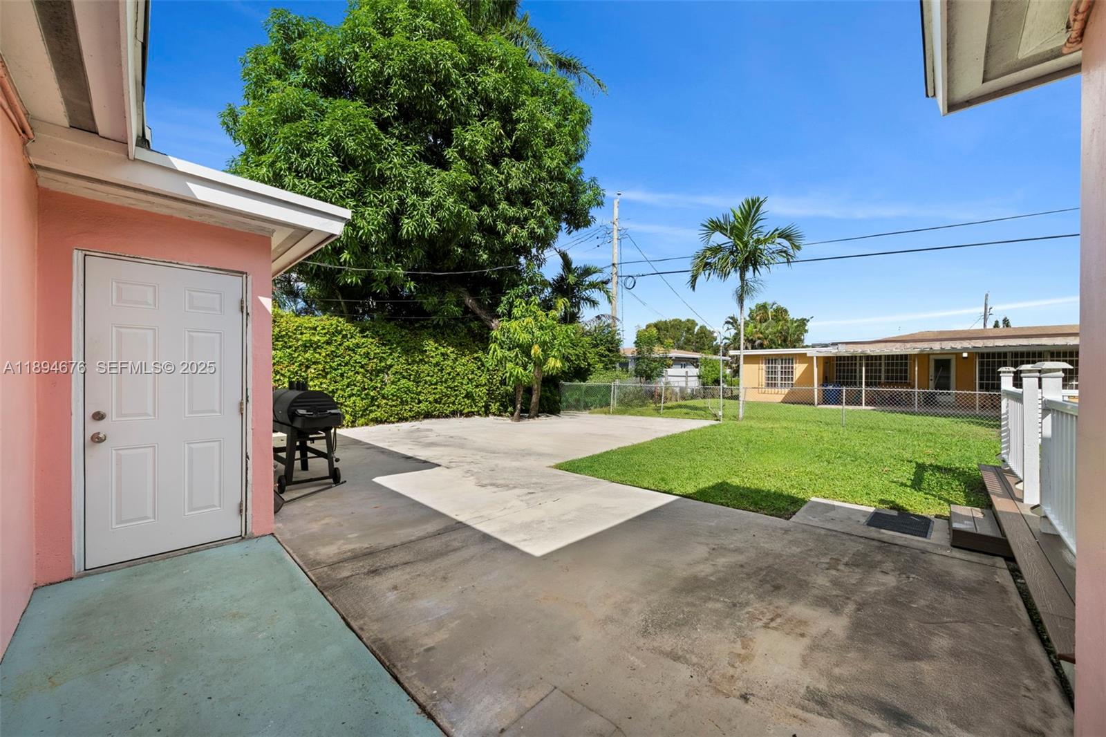 1271 Northwest 87th Street Miami, FL 33147 - Photo 25 of 29 a view of a house with a yard and potted plants