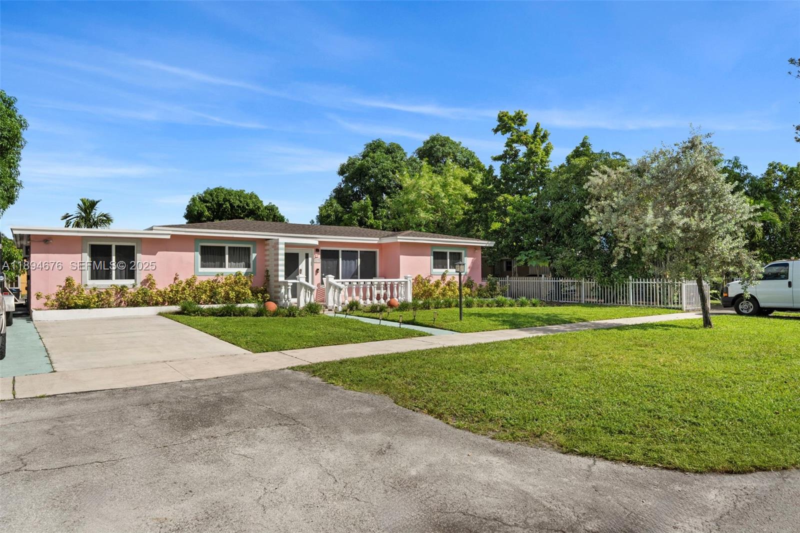 1271 Northwest 87th Street Miami, FL 33147 - Photo 3 of 29 a front view of a house with a yard and trees