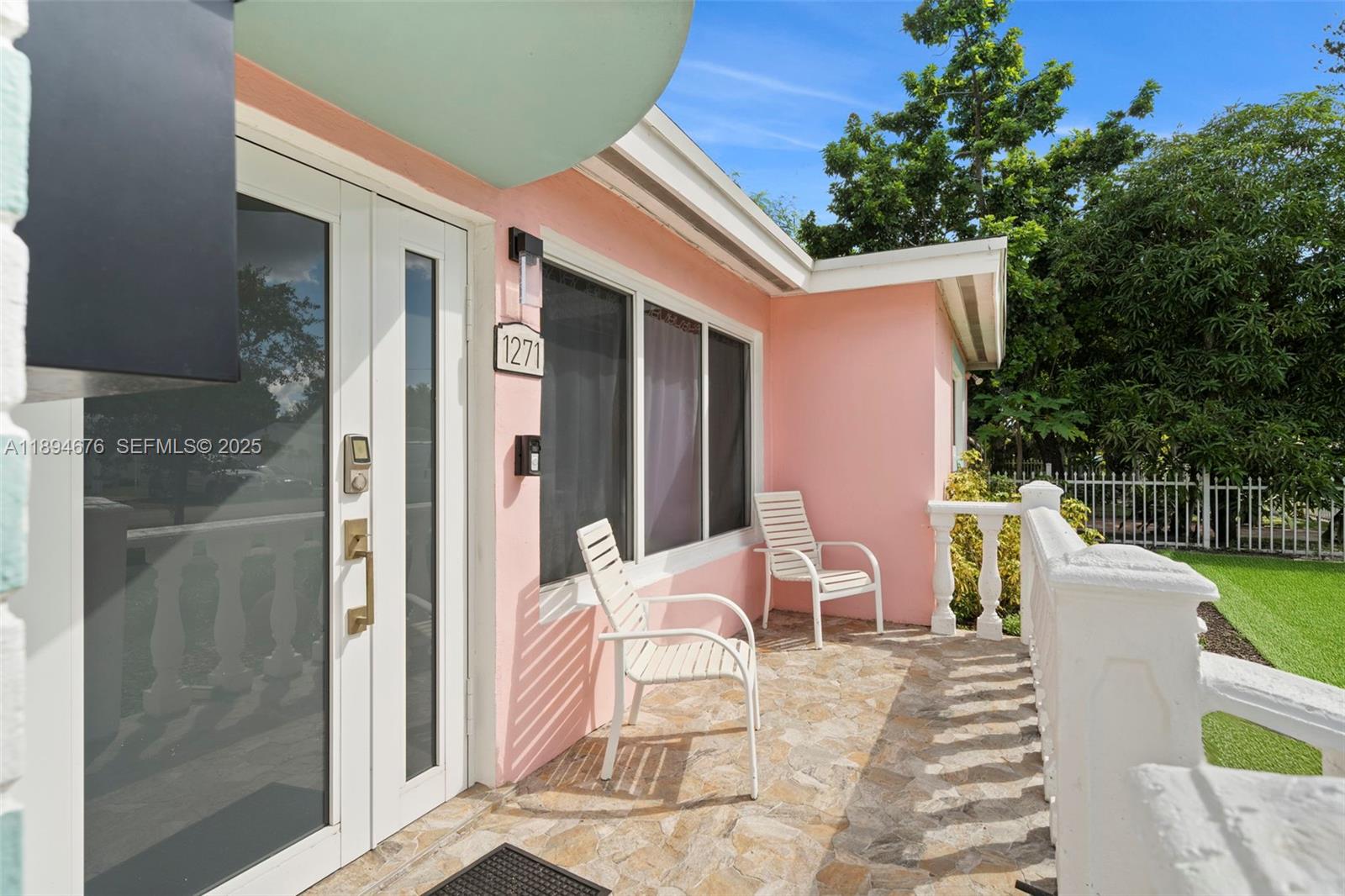 1271 Northwest 87th Street Miami, FL 33147 - Photo 4 of 29 a view of a patio with a table and chairs and couches