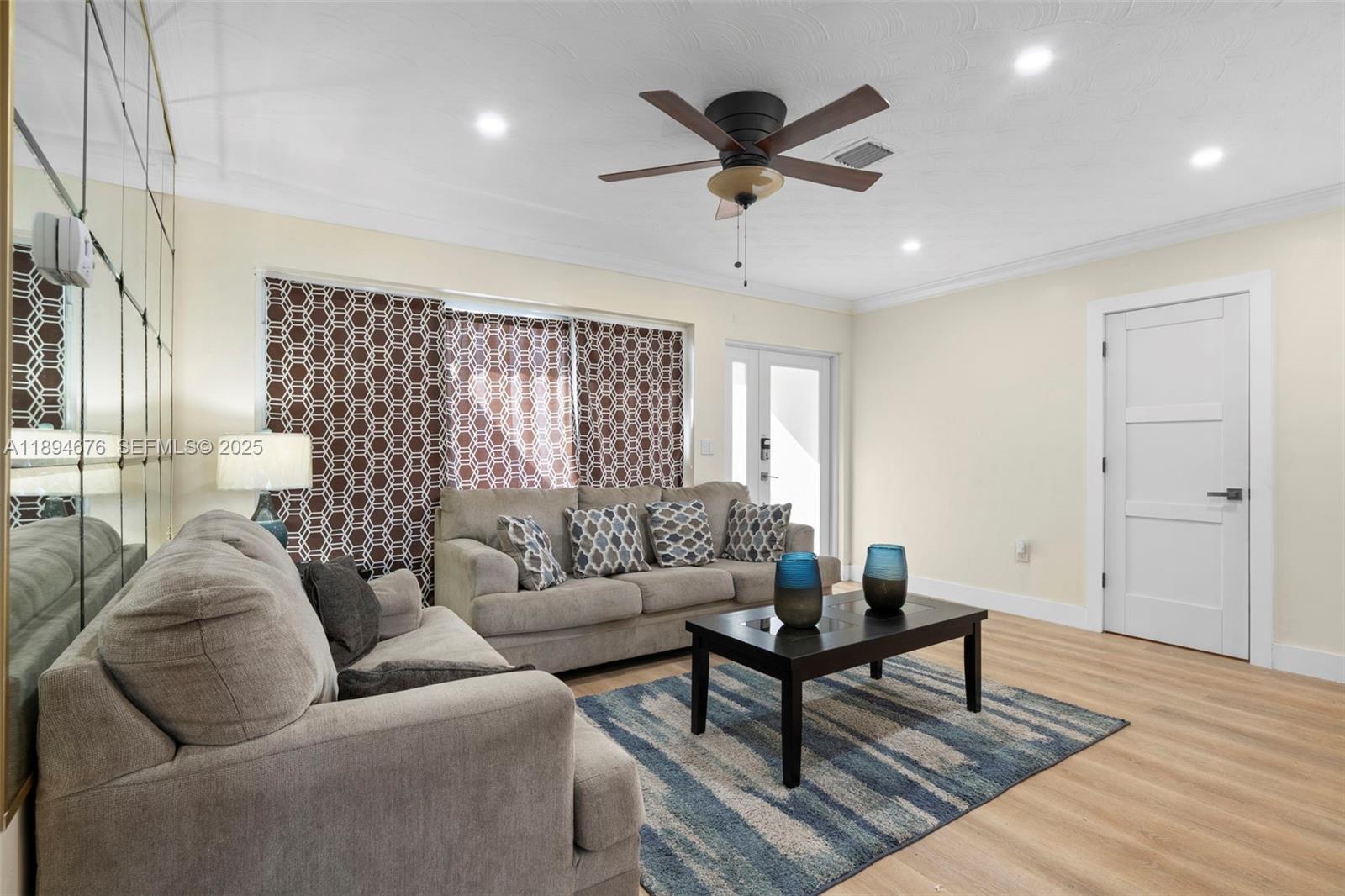 1271 Northwest 87th Street Miami, FL 33147 - Photo 5 of 29 a living room with furniture and a large window