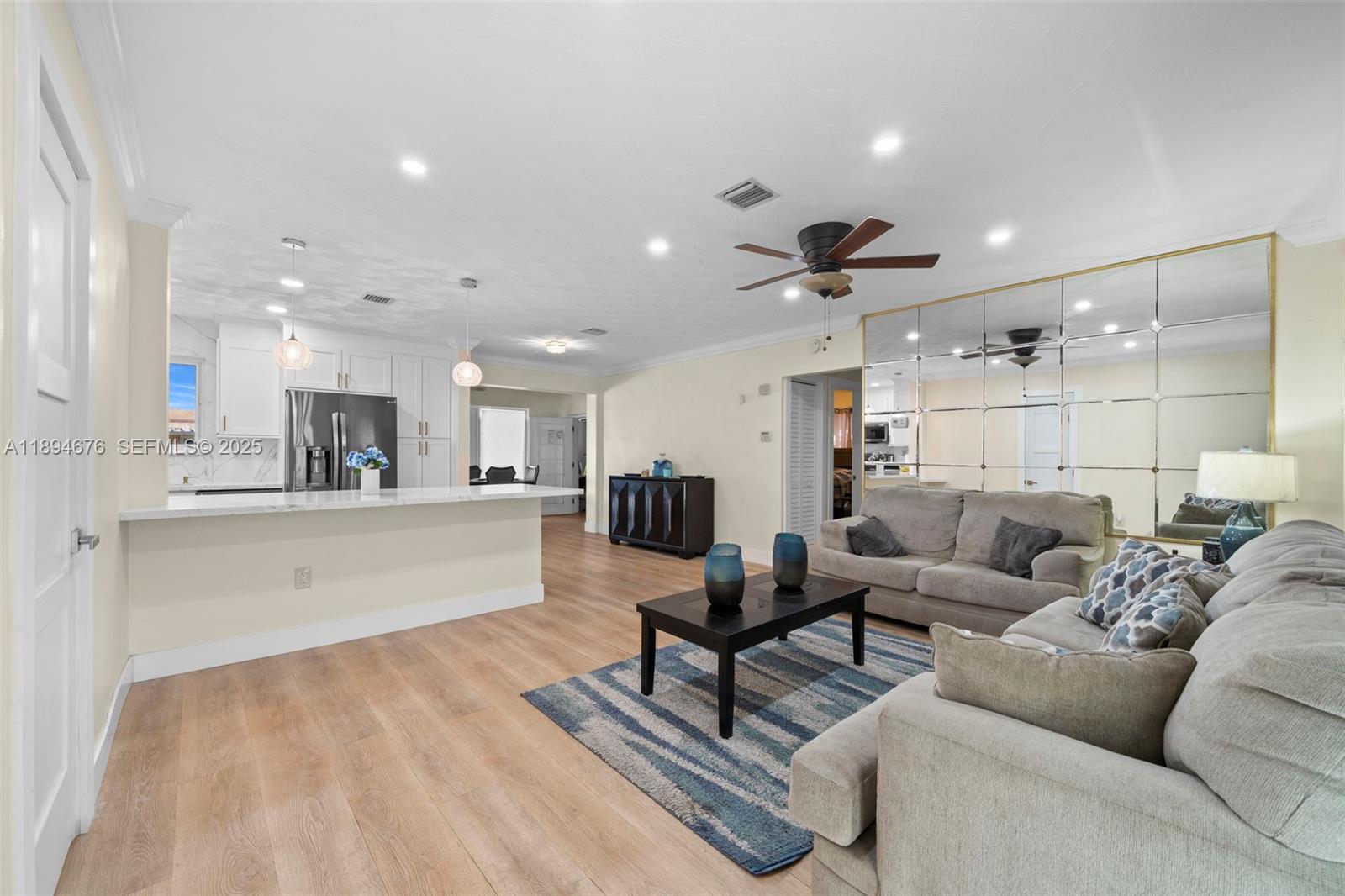 1271 Northwest 87th Street Miami, FL 33147 - Photo 6 of 29 a living room with furniture and kitchen view