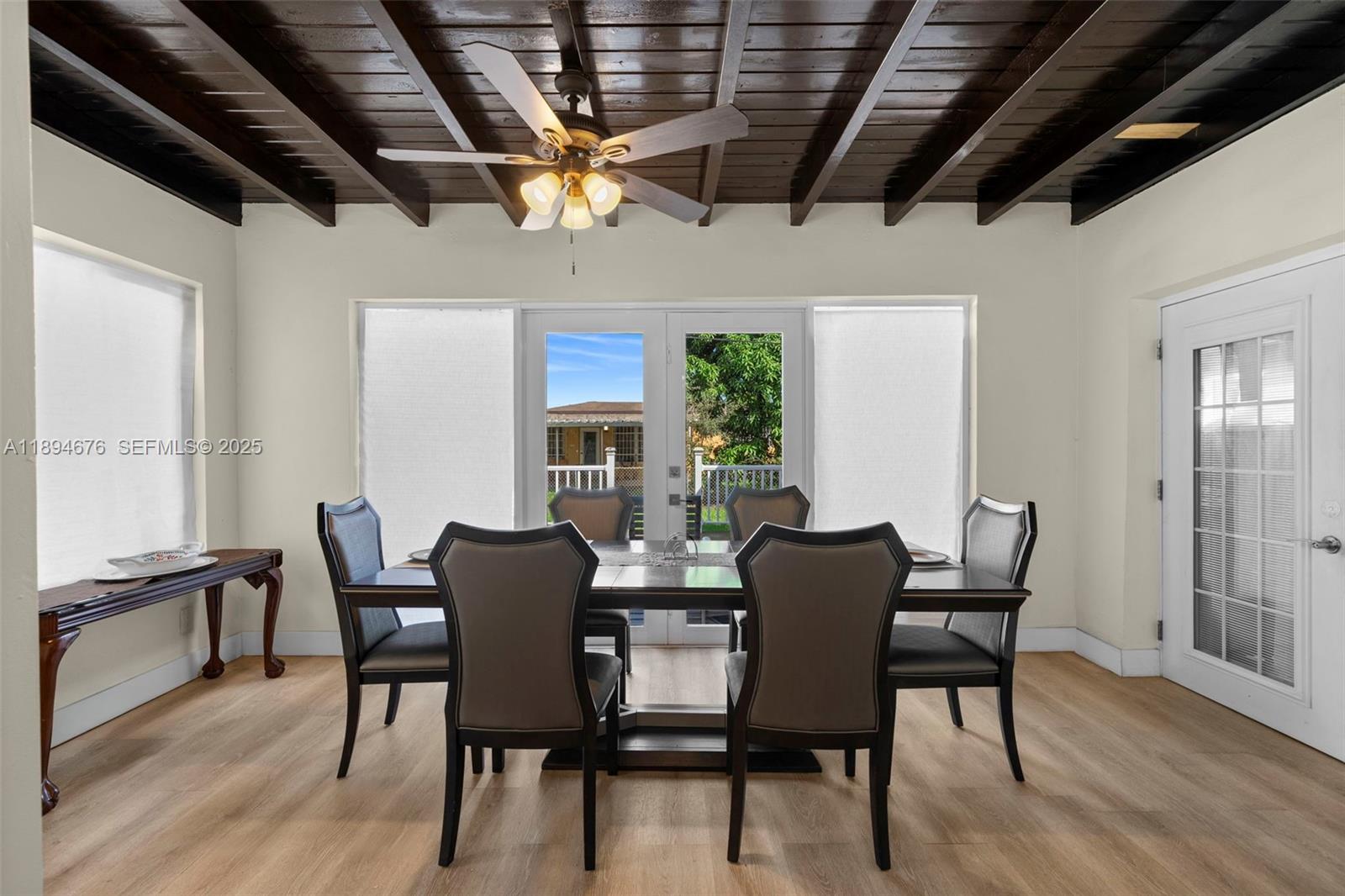 1271 Northwest 87th Street Miami, FL 33147 - Photo 10 of 29 a view of a dining room with furniture window and wooden floor