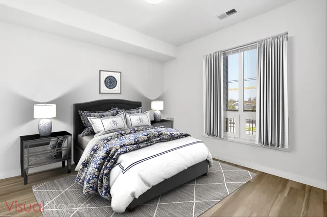 a bedroom with a bed and a large window